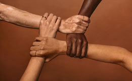 multi-racial hands held together in a circle