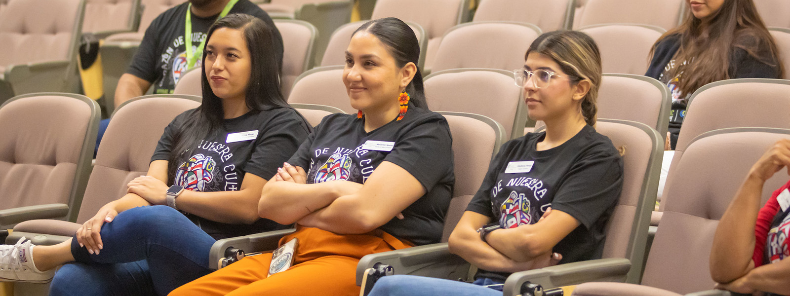 group of latino students sitting in a lecture hall