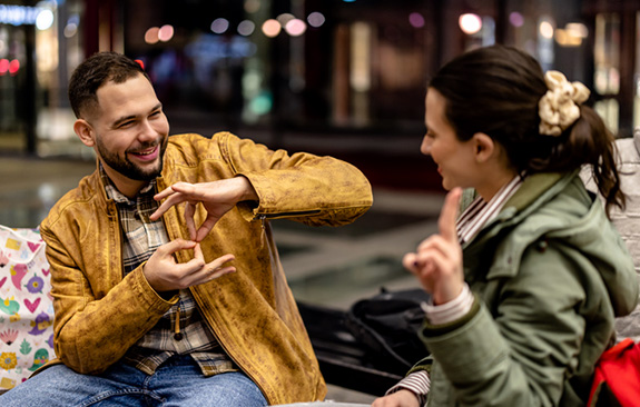 A young couple communicating in sign language