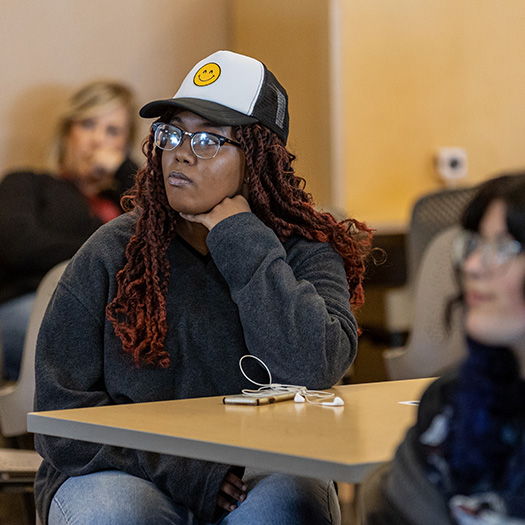 A woman listening to a lecture