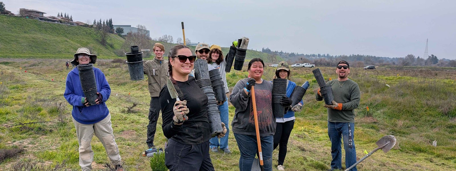 Group photo of students ready to plant trees