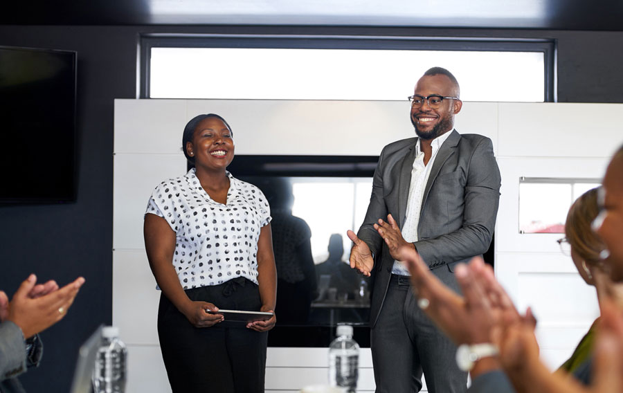 business professionals in a meeting, smiling and laughing