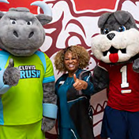 Dr. Kim E. Armstrong posing  with the Crush mascot and Fresno State's Timeout
