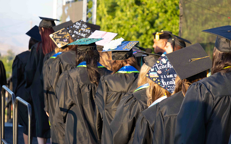 student graduates standing in a line
