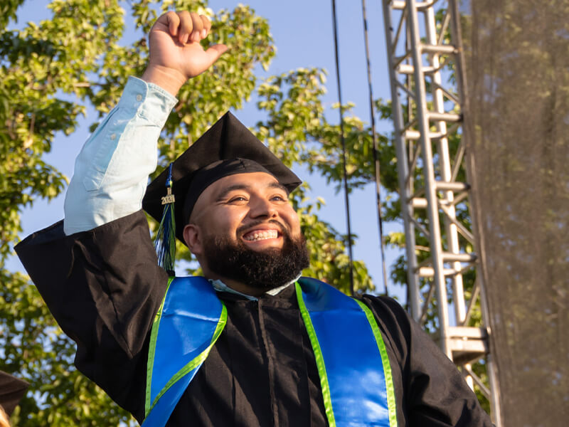 Male student pumping his fist at the 2024 Commencement Ceremony