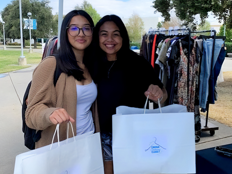 Two female students at the Crush Clothing Closet booth at the Job Fair