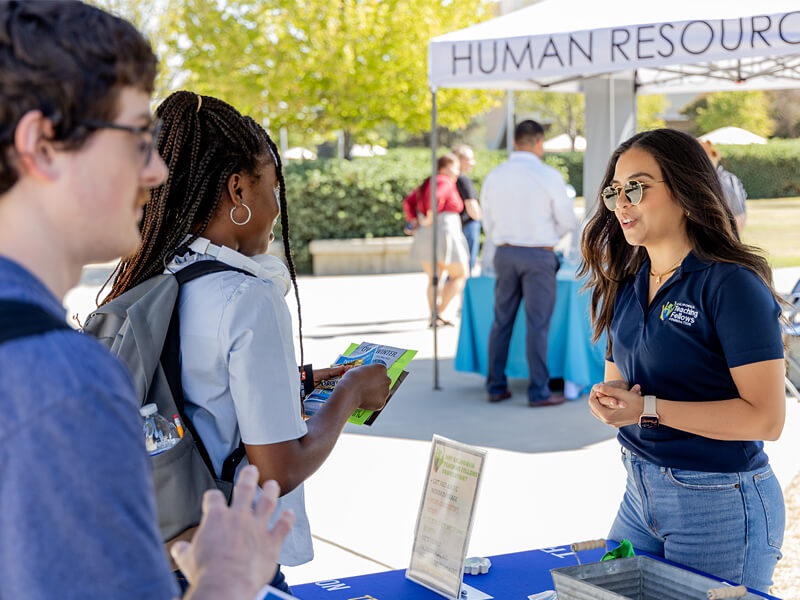 Students talking with a vendor at the Job Fair at Clovis Community College