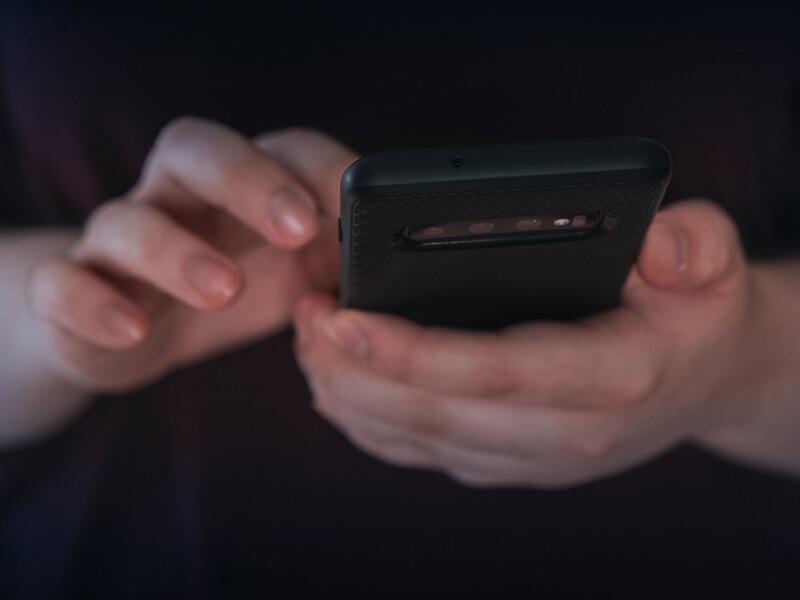 student holding a mobile phone