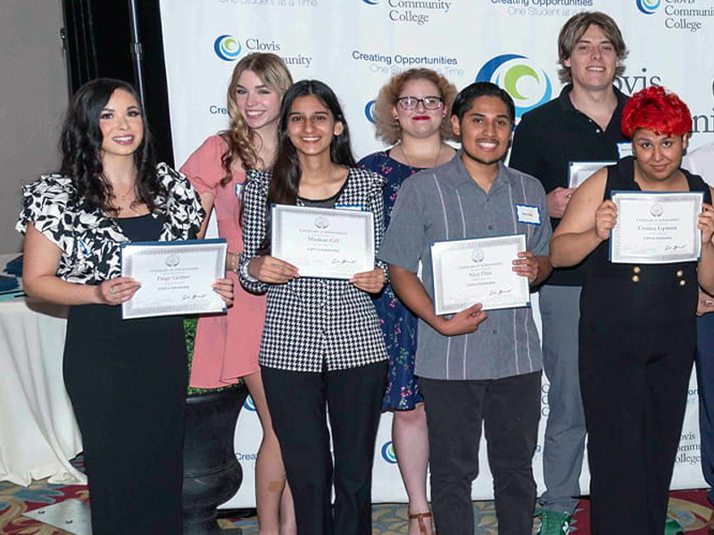 scholarship recipients posing with Dr. Kim E. Armstrong