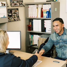 Clovis Community College staff member assisting a male student