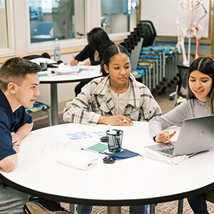 students engaged in group conversation at the Tutorial Center