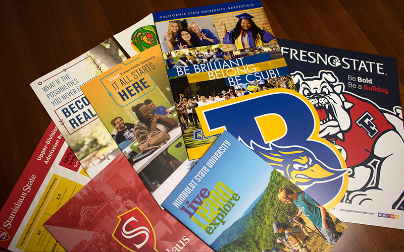 University brochures scattered on a table