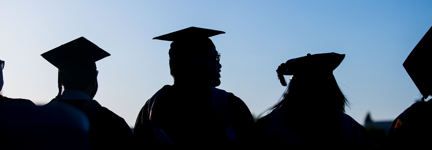 silhouette of graduates at sunset