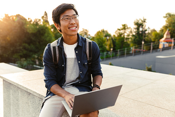 asian american student holding a backpack