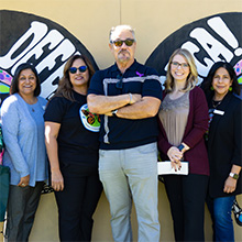 Some people standing in front of a sign that says "Defend D.A.C.A."